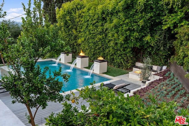 view of swimming pool with pool water feature