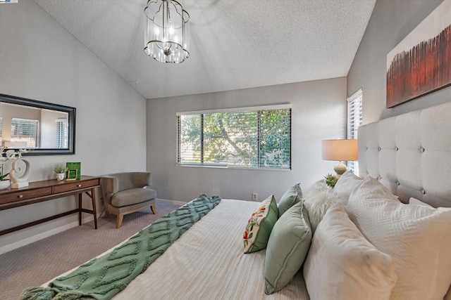 bedroom featuring carpet flooring, lofted ceiling, a textured ceiling, and an inviting chandelier