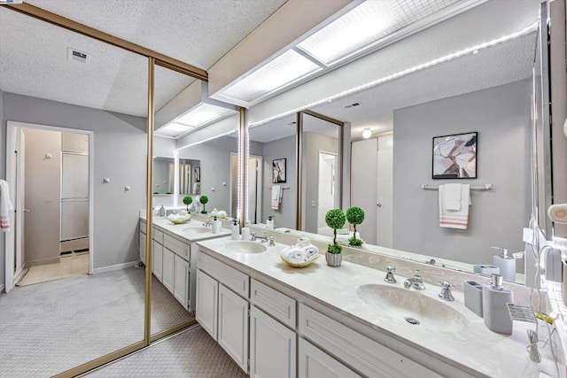 bathroom with vanity and a textured ceiling