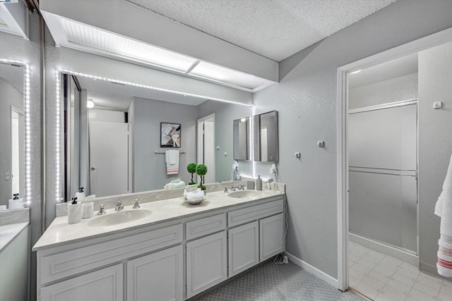 bathroom with vanity and a textured ceiling