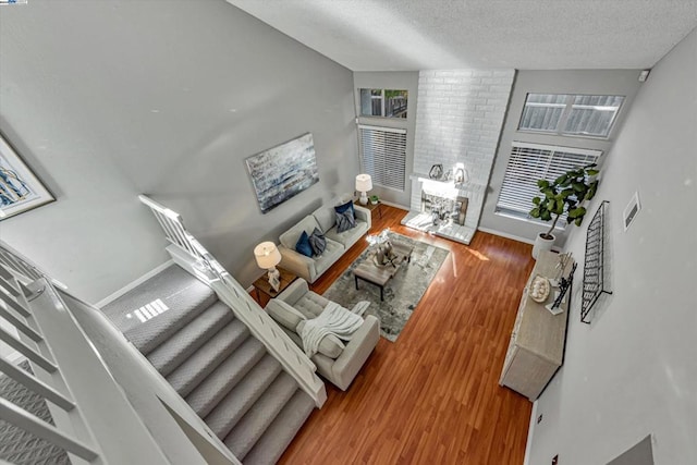 living room featuring wood-type flooring and a textured ceiling