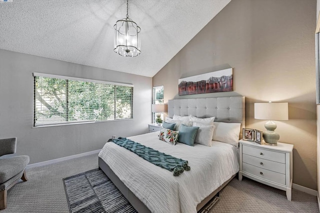 carpeted bedroom featuring a textured ceiling, a chandelier, and vaulted ceiling