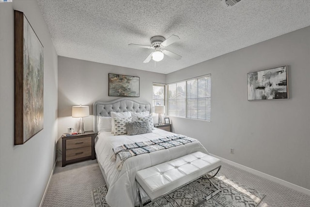 carpeted bedroom with ceiling fan and a textured ceiling