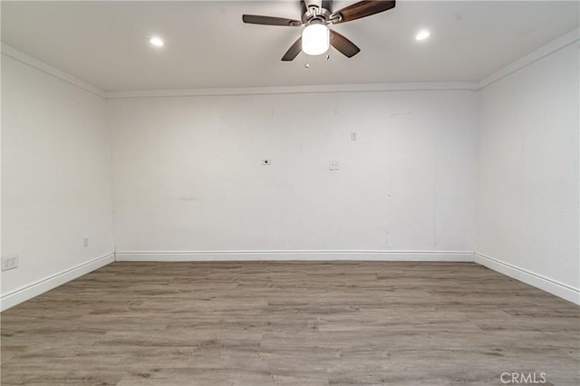 empty room featuring light hardwood / wood-style floors, ceiling fan, and ornamental molding