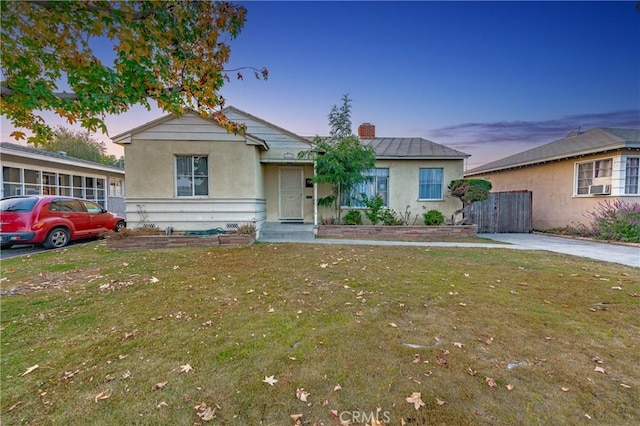 ranch-style house featuring a yard and cooling unit