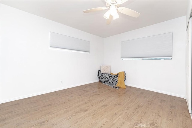 unfurnished room featuring light wood-type flooring and ceiling fan