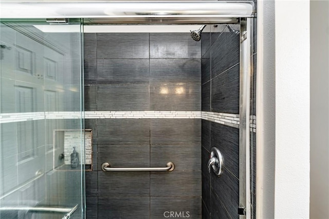 bathroom with a shower with shower door