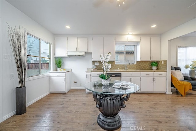 kitchen with plenty of natural light, white cabinets, and light wood-type flooring