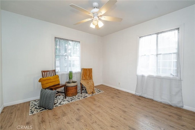 sitting room featuring ceiling fan and light hardwood / wood-style floors