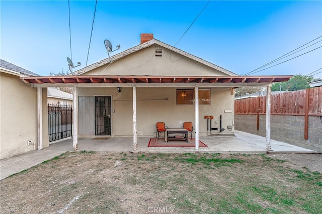 rear view of property with a patio area