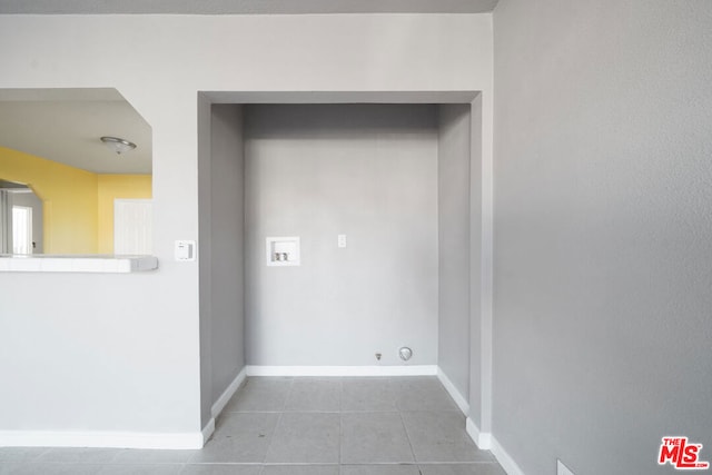 clothes washing area with gas dryer hookup, light tile patterned floors, and hookup for a washing machine