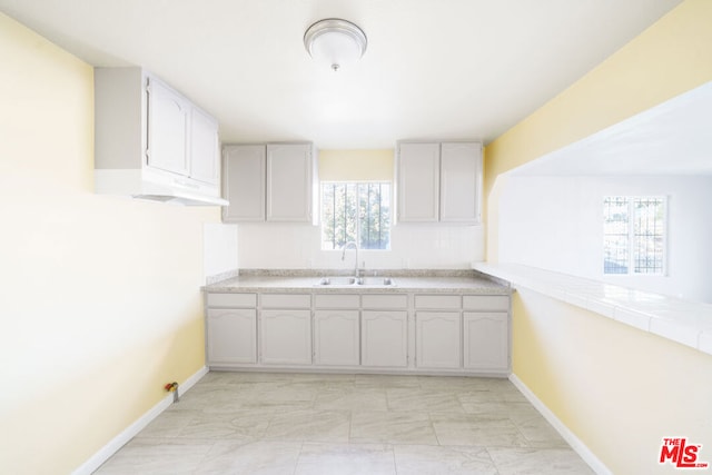 kitchen with tile counters and sink