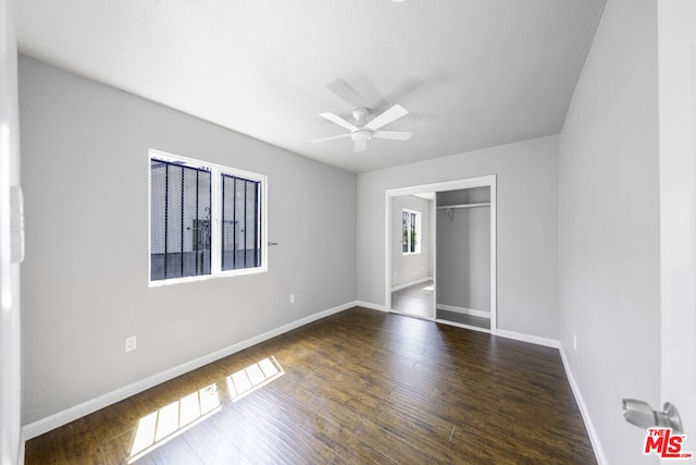 unfurnished bedroom featuring ceiling fan, a closet, and dark hardwood / wood-style floors