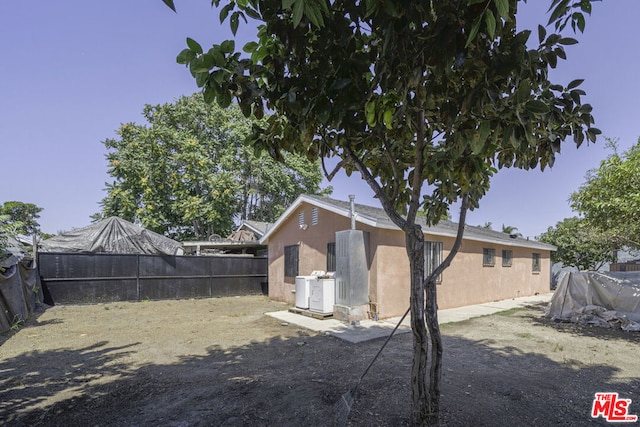 view of side of home with central AC