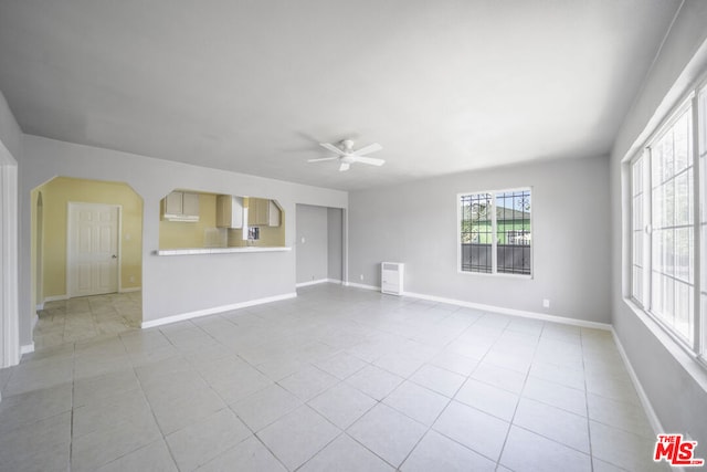 tiled spare room with ceiling fan