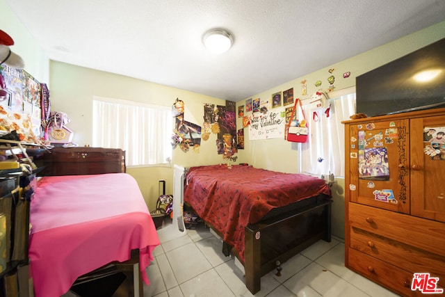 bedroom with light tile patterned floors