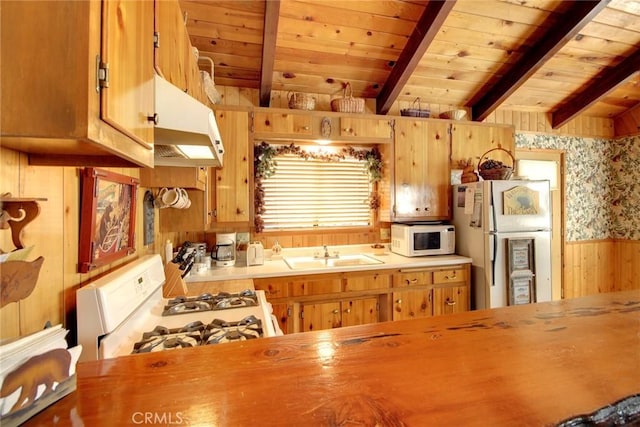 kitchen with beam ceiling, white appliances, wood ceiling, and sink