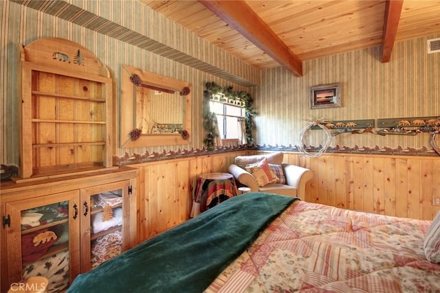 bedroom featuring beam ceiling, wood walls, and wood ceiling