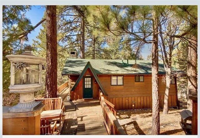 exterior space with a wooden deck and a sunroom