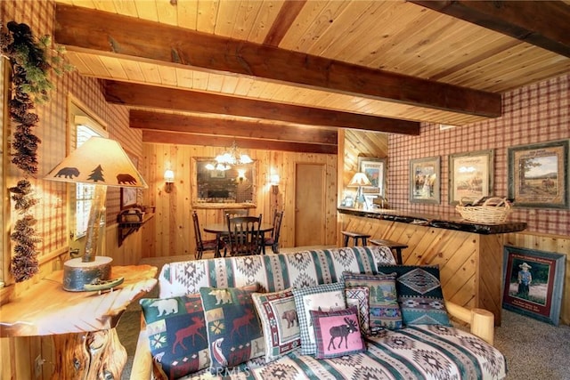 carpeted living room featuring wood walls, wooden ceiling, beam ceiling, and a chandelier