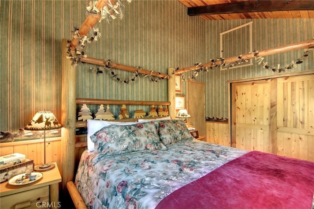 bedroom with vaulted ceiling with beams and wood walls