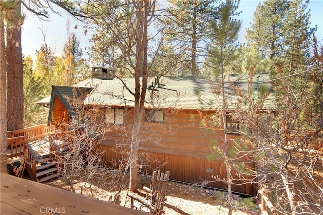 view of side of property with a wooden deck