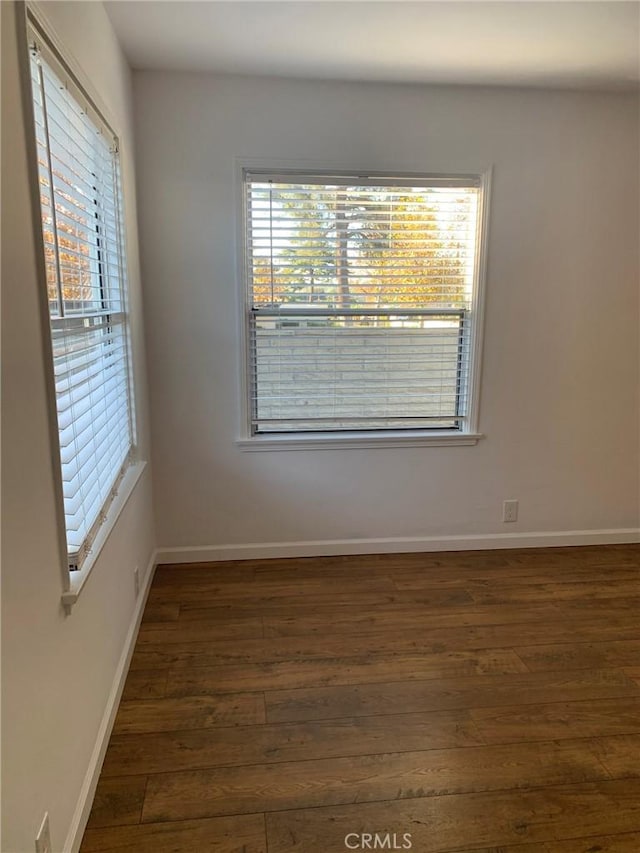 spare room with dark hardwood / wood-style floors