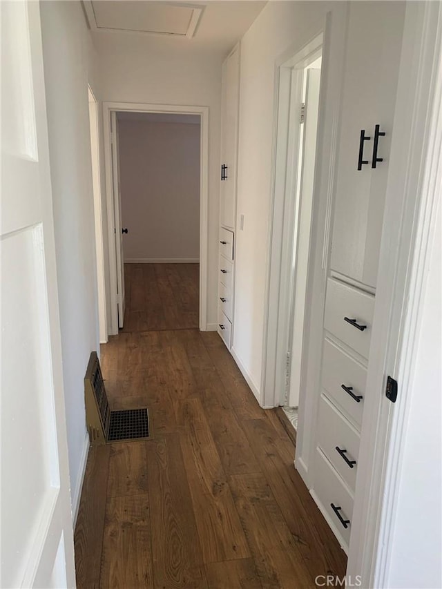 hallway with dark hardwood / wood-style flooring