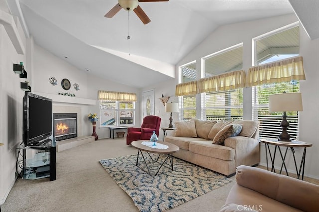 carpeted living room featuring high vaulted ceiling, ceiling fan, and a wealth of natural light