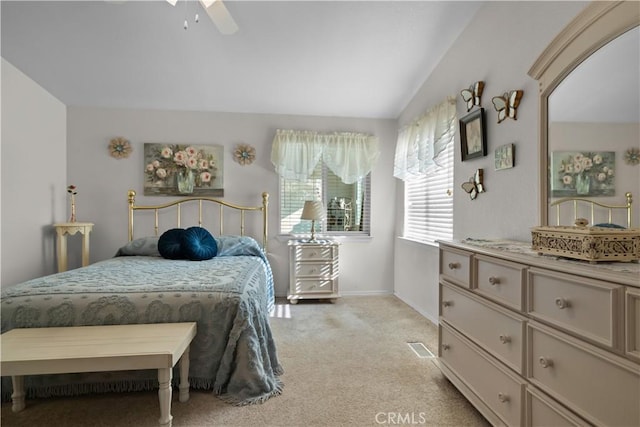 bedroom featuring ceiling fan, vaulted ceiling, and light colored carpet