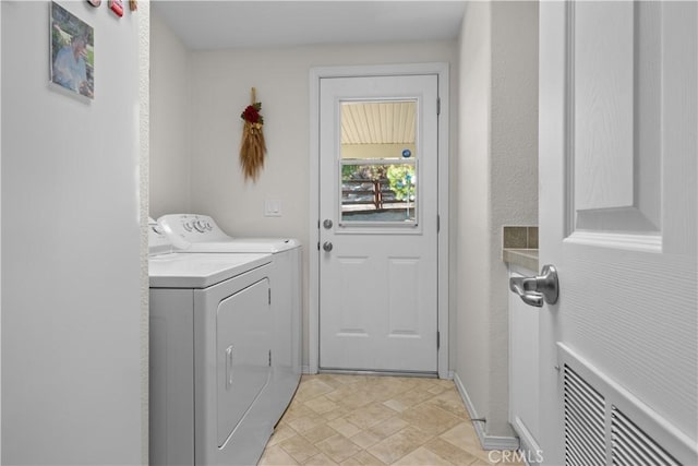 clothes washing area with separate washer and dryer