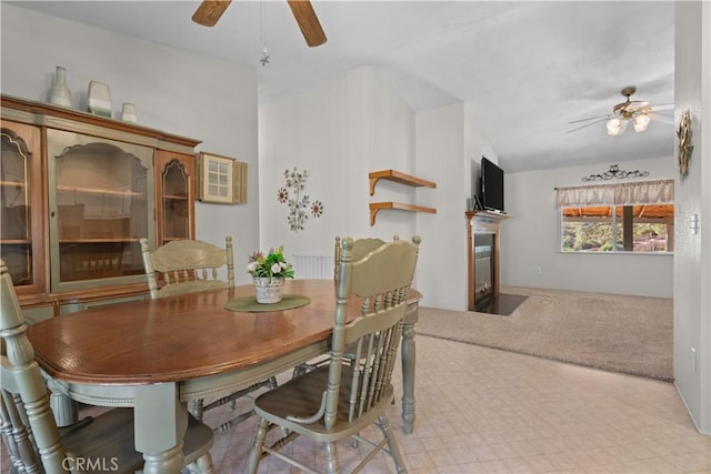 carpeted dining space featuring ceiling fan