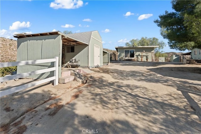 view of side of home with an outdoor structure