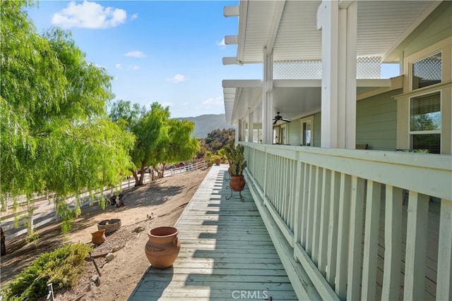 view of home's exterior featuring ceiling fan and a mountain view