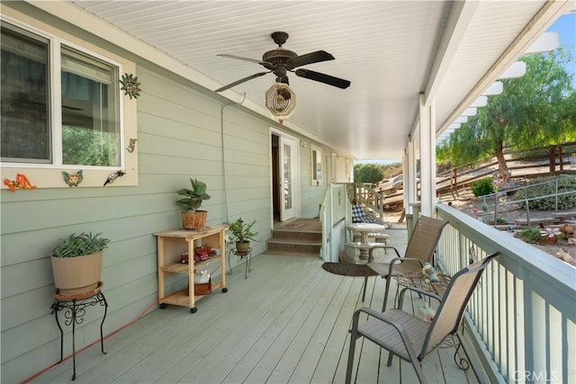 wooden terrace featuring ceiling fan