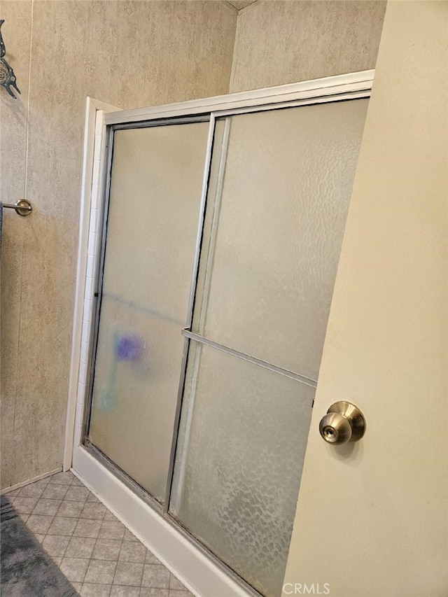 bathroom with tile patterned floors and walk in shower