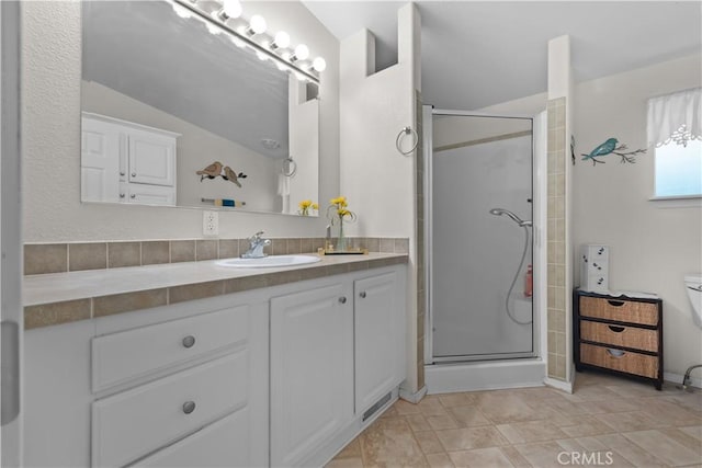 bathroom with lofted ceiling, a shower with door, and vanity