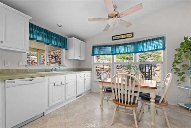 kitchen featuring tile counters, white dishwasher, ceiling fan, sink, and white cabinetry