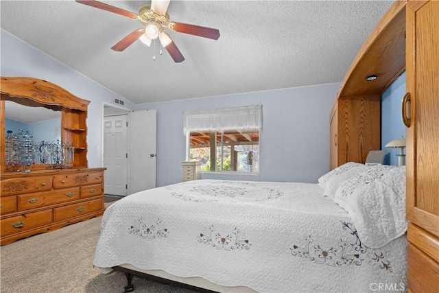 bedroom featuring ceiling fan, carpet floors, and a textured ceiling