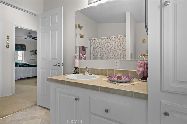 bathroom with ceiling fan, walk in shower, and vanity