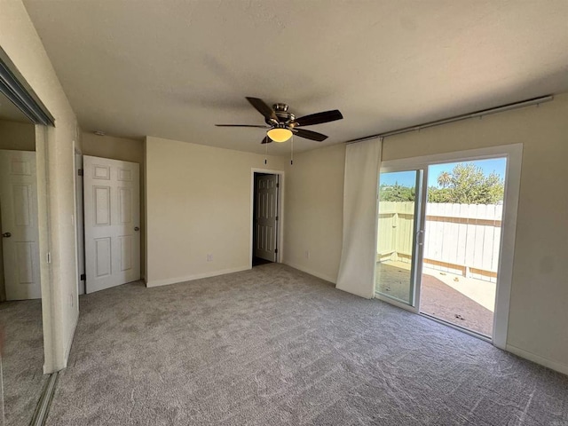 unfurnished bedroom featuring access to exterior, ceiling fan, and light colored carpet