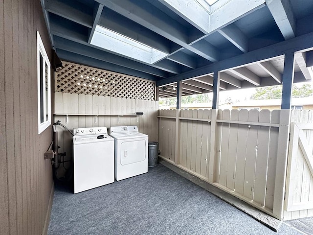 washroom featuring washer and clothes dryer and dark carpet