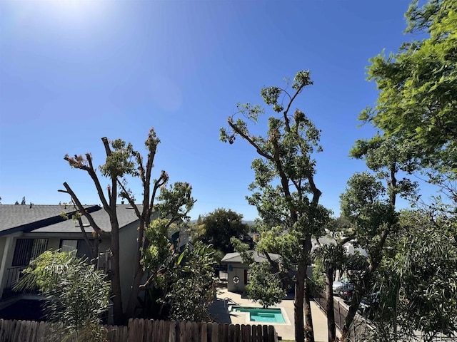 view of side of home featuring a fenced in pool and a patio