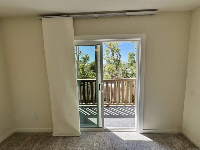 doorway with carpet flooring