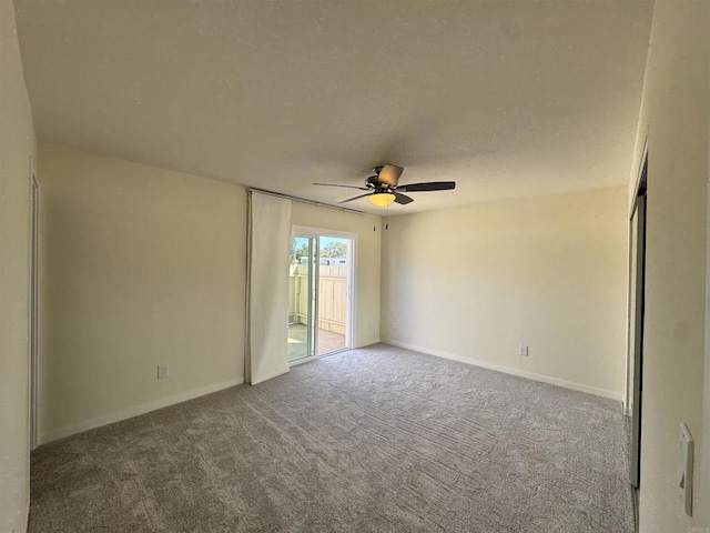 empty room featuring carpet flooring and ceiling fan