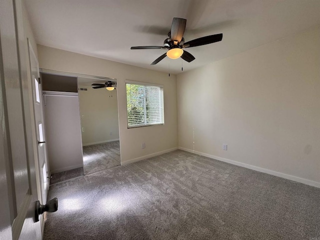 carpeted empty room featuring ceiling fan