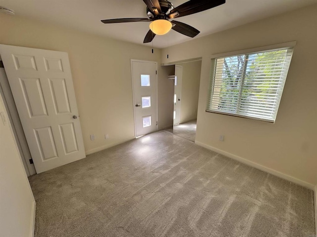 carpeted empty room with ceiling fan