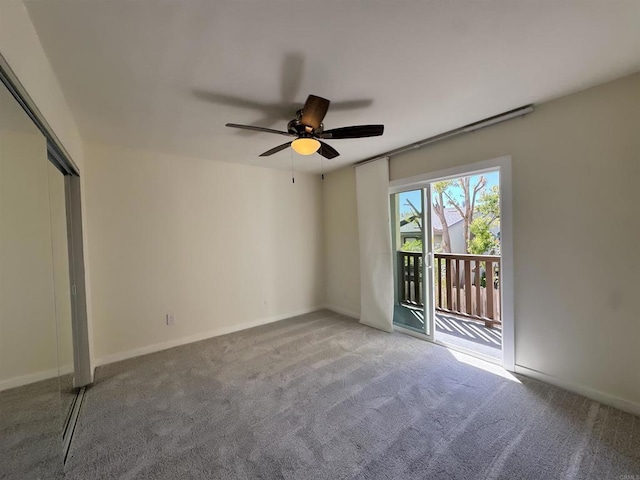 empty room featuring carpet floors and ceiling fan