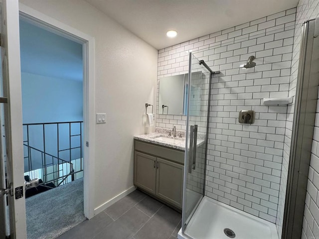 bathroom with tile patterned floors, vanity, and tiled shower