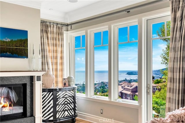 living room featuring a water view and ornamental molding